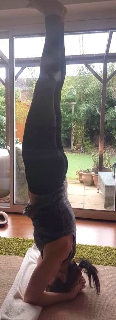 Woman practising supported headstand